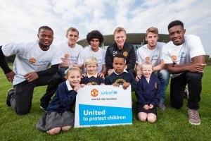 Manchester United manager David Moyes and players Patrice Evra, Darren Fletcher, Marouane Fellaini, David de Gea and Danny Welbeck with local school children in Manchester, celebrating the renewal of the club's partnership with UNICEF