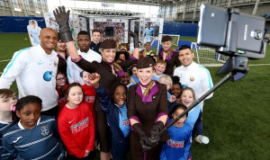 Sergio Aguero, Vincent Kompany, Brandon Barker, and Kelechi Iheanacho with primary school kids and Etihad Airways staff