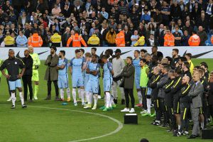 Man City players and Pep Guardiola wait for Pablo Zabaleta return to the pitch to say farewell