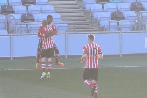 Nathan Tella celebrates his goal against Man City EDS with Harry Reed