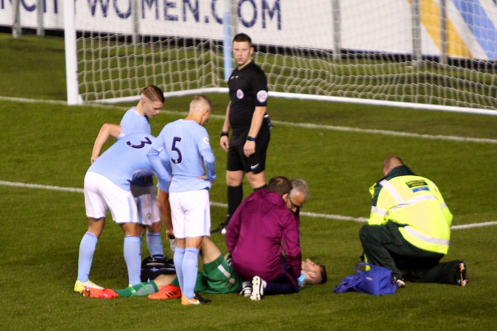 Daniel Grimshaw receives treatment after putting the ball out following injury