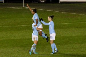 Nikita Parris (centre) celebrates the winning goal against LSK Kvinner with Izzy Christiansen (left) and Jane Ross (right)