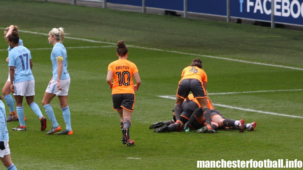 Remi Allen is buried by team mates after scoring the opening goal for Reading Women