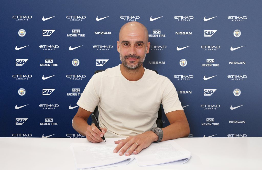 Pep Guardiola signs new contract to stay at Man City until 2021