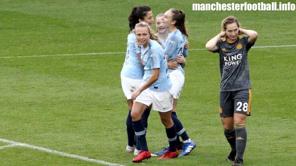 Nadia Nadim, Claire Emslie, and Jess Park (left to right) celebrate Tessa Wullaert's first goal for Manchester City women to the dismay of Leicester City Women's player Maddy Cusack