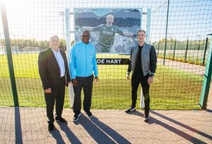 Mike Summerbee and Alex Williams with Joe Hart and his mosaic at the City Football Academy