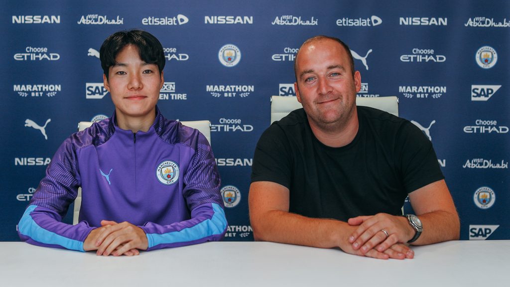 New signing Lee Geum-min with women's team manager Nick Cushing