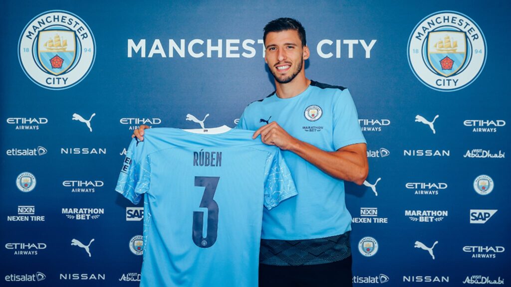 Manchester City defender Ruben Dias shows off his new number 3 shirt