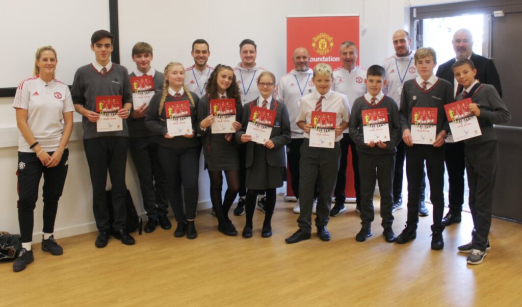 Denis Irwin with students at Central Academy in Carlisle