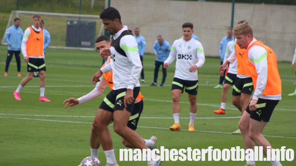 City midfielder Rodri holds off Phil Foden