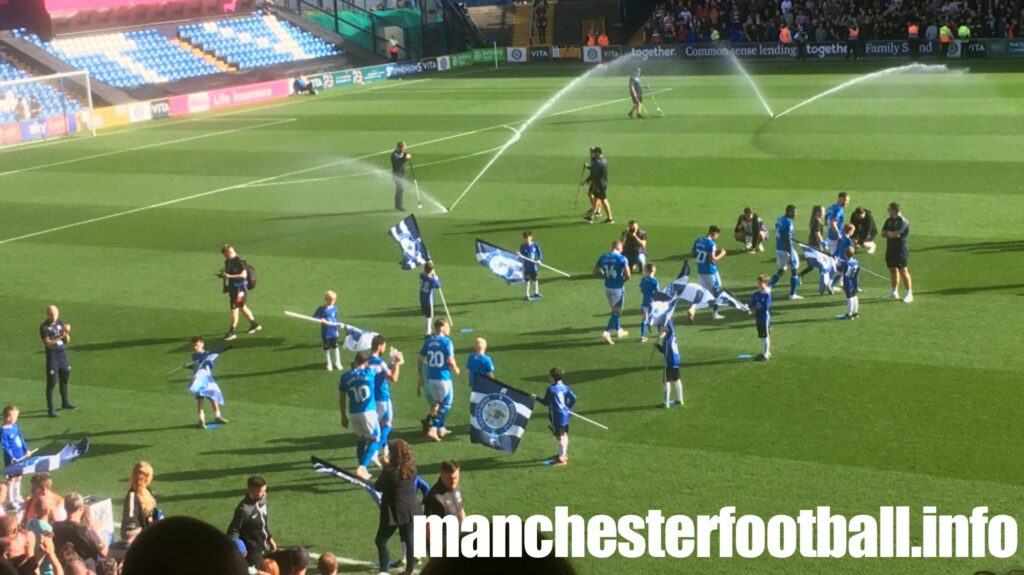 FC Blue Star Rockets U9s flag bearers at Stockport County - Saturdsy October 7 2023